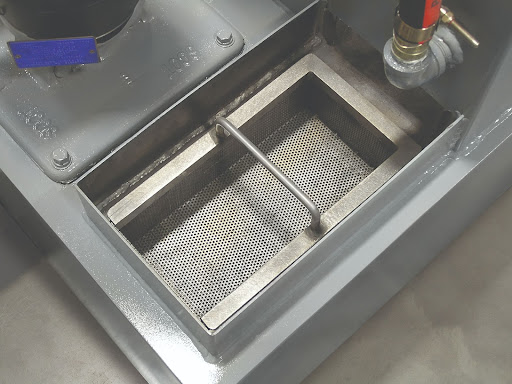 Chip basket on the Orca model aqueous parts washer.