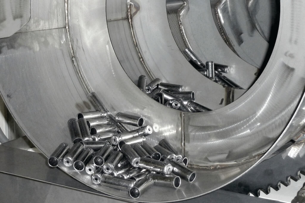 Inside of a steel rotary drum parts washer.