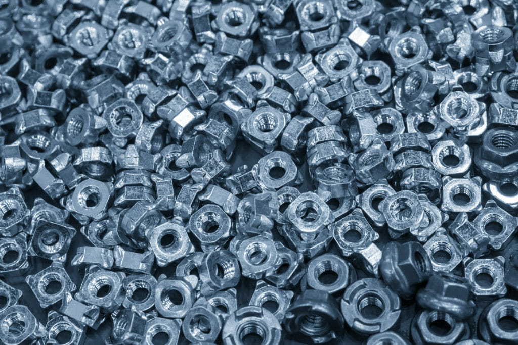 A closeup on a large pile of nuts and fasteners.