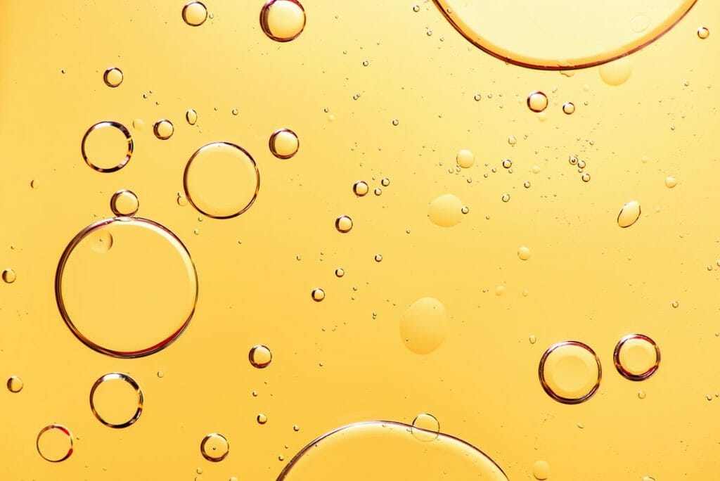 Abstract image of bubbles in a yellow liquid.