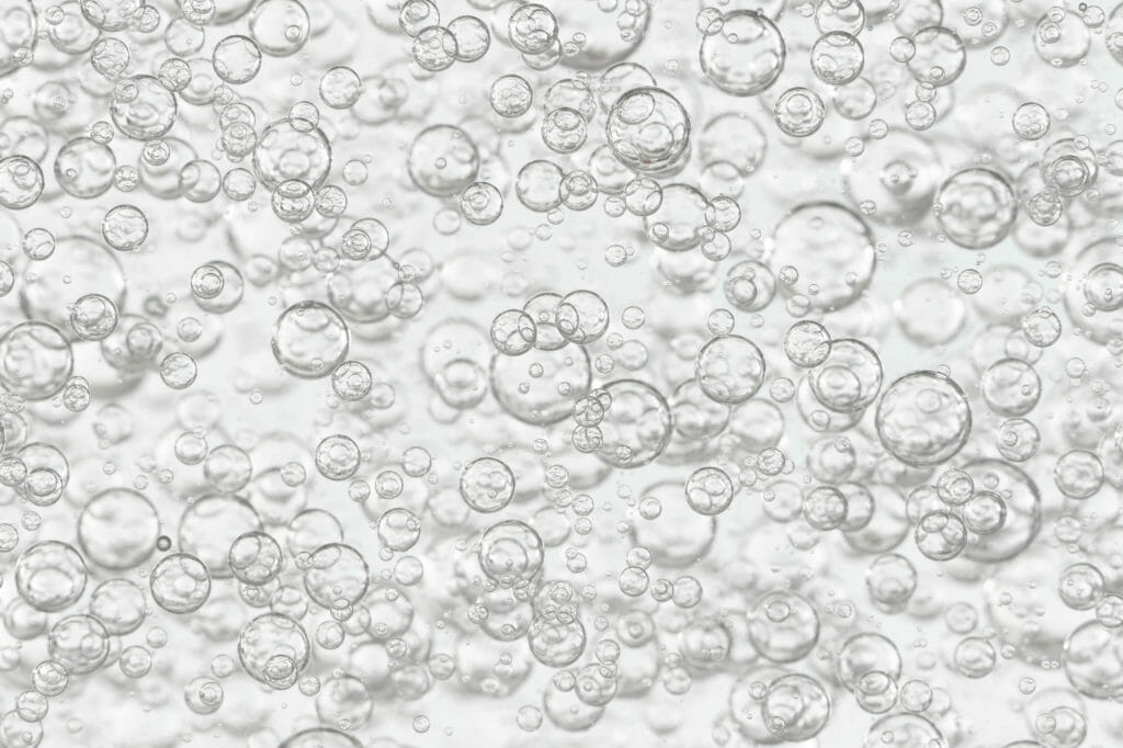 Closeup on water bubbling as a representation of heated aqueous cleaning solution.
