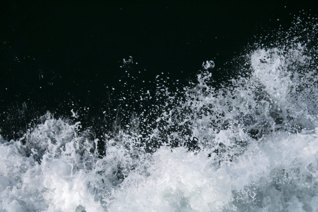 Closeup of a water splash over a black background.