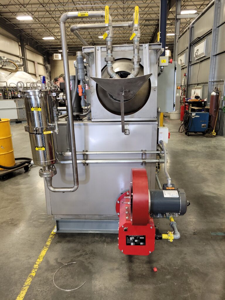 A heated parts washer that uses natural gas sits inside a facility.
